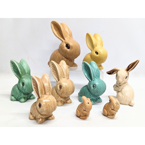 687 - A quantity of 9 Sylvac pottery rabbit figures, including a pair of Sylvac pottery salt and pepper sh... 
