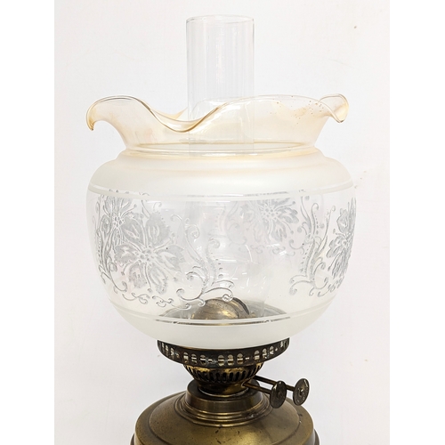 127 - An early 20th century brass double burner oil lamp with glass shade and funnel. 55cm