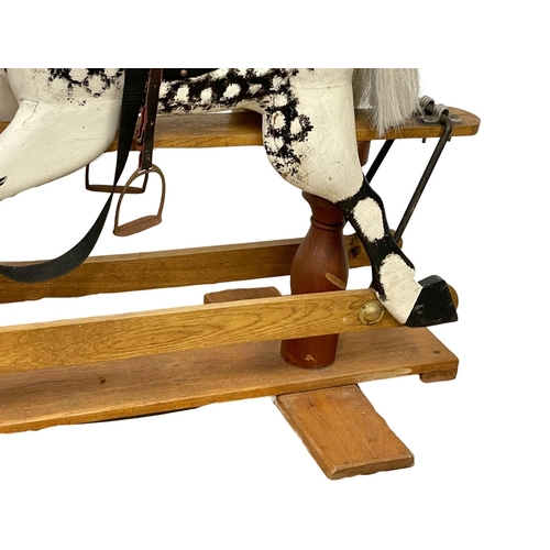 118 - A vintage wooden rocking horse. 119x91cm