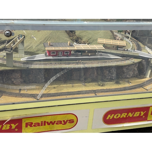 60A - A large Hornby Railways train set in display case. 158x116x64cm.