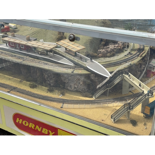 60A - A large Hornby Railways train set in display case. 158x116x64cm.