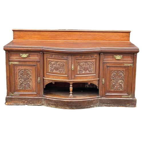 1626 - A large late Victorian oak sideboard. Circa 1890. 214x79x120cm