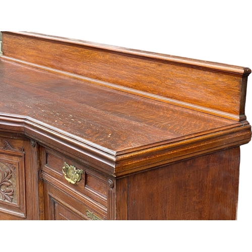 1626 - A large late Victorian oak sideboard. Circa 1890. 214x79x120cm