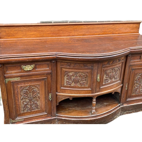 1626 - A large late Victorian oak sideboard. Circa 1890. 214x79x120cm