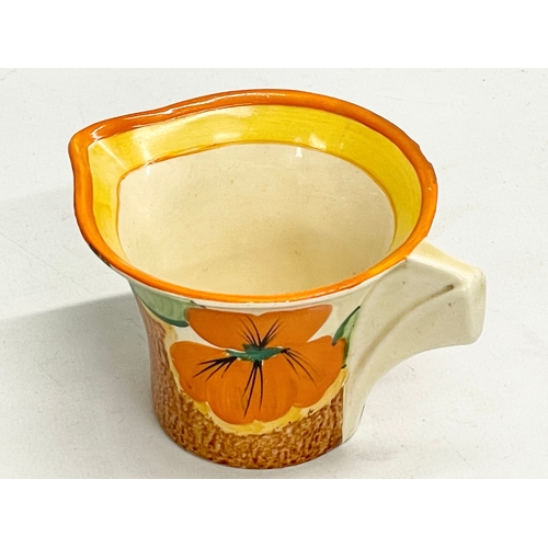 28 - A 1920’s Clarice Cliff Bizarre Nasturtium milk jug. Art Deco. 11x8x6cm.