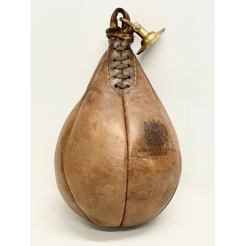 72 - An early 20th century leather boxing speed punching bag. Portobello Road Sports, London 1919.