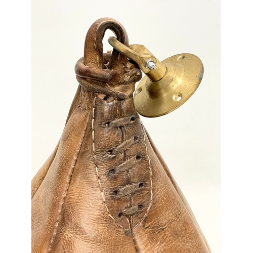 72 - An early 20th century leather boxing speed punching bag. Portobello Road Sports, London 1919.