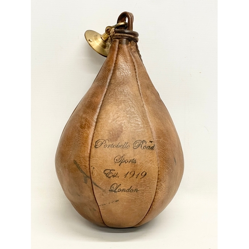 72 - An early 20th century leather boxing speed punching bag. Portobello Road Sports, London 1919.