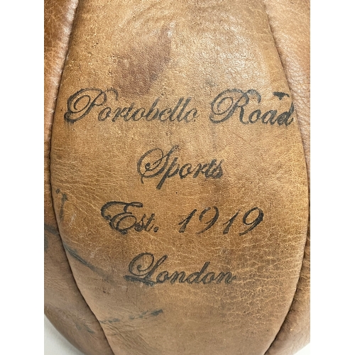 72 - An early 20th century leather boxing speed punching bag. Portobello Road Sports, London 1919.