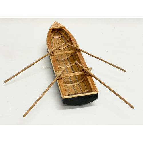 144 - An Irish hand made Currach model in box. Made in Connemara. Boat measures 31cm.