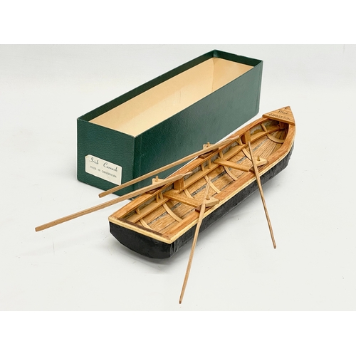 144 - An Irish hand made Currach model in box. Made in Connemara. Boat measures 31cm.