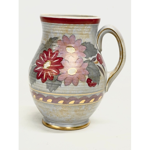 264 - A Charlotte Rhead pottery jug. Designed for Crown Ducal. 19x21cm.