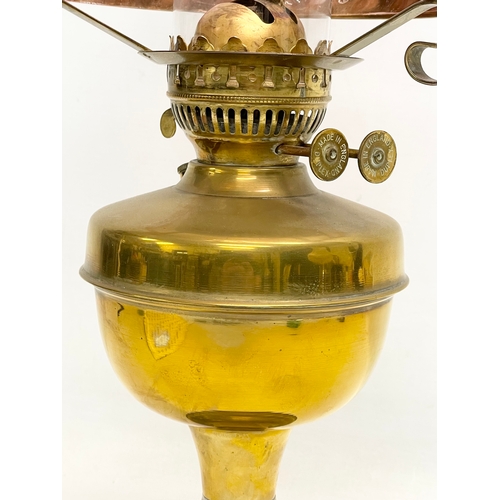 76 - A vintage brass double burner oil lamp. 52cm.