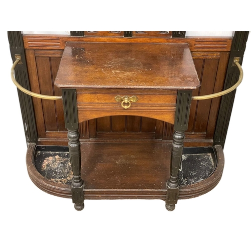 826 - A large Victorian oak and ebonised hallstand in the Aesthetic Movement. Circa 1880. 114x44x217cm.