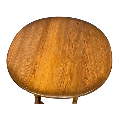 911 - An Ercol Elm drop leaf coffee table. Open 92x106x49cm closed 43x106x49cm