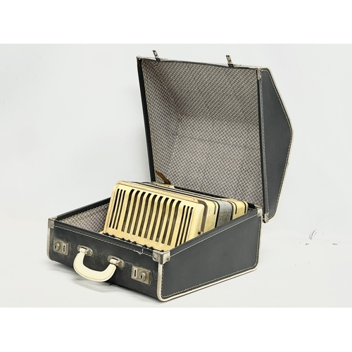 204 - A Hohner Student IV accordion in case.