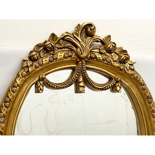 77 - A large ornate gilt framed mirror. 79x115cm