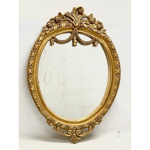 77 - A large ornate gilt framed mirror. 79x115cm