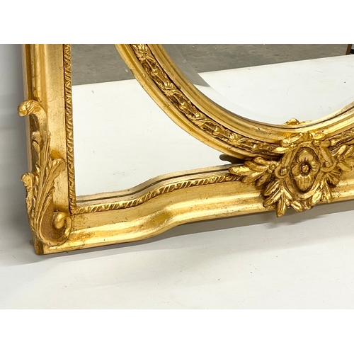 78 - A large ornate gilt framed mirror. 83x132cm