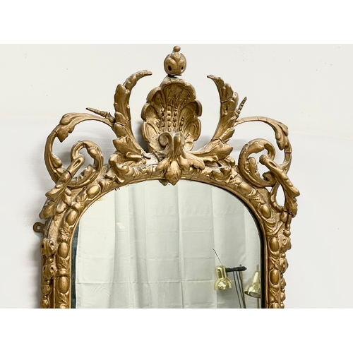 23 - A long Victorian ornate gilt framed mirror. 44x110cm