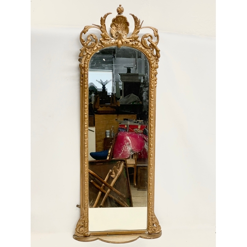 23 - A long Victorian ornate gilt framed mirror. 44x110cm