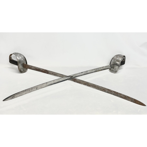 32 - A pair of late 19th/early 20th century Wilkinson made swords. Stamped WD (War Department) 102cm.