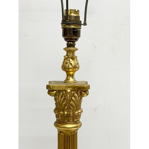 79 - A tall good quality gilt brass table lamp with Corinthian style pillar. Base measures 18x63cm.