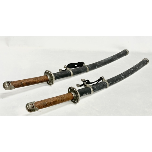 276 - A pair of good quality samurai style swords. 93cm