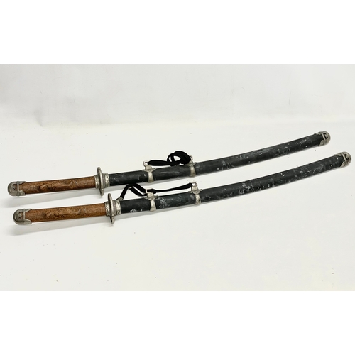 276 - A pair of good quality samurai style swords. 93cm