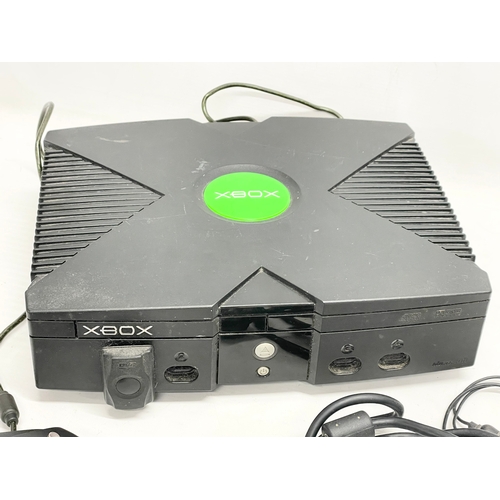 205 - An XBOX console with controller and leads.