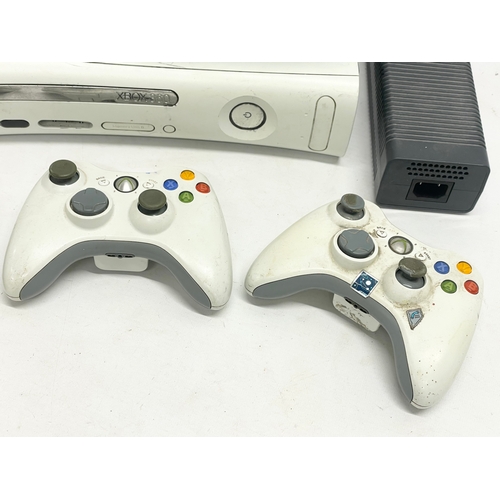 209 - An XBOX 360 console with 3 controllers, a Kinect, an XBOX remote and leads.