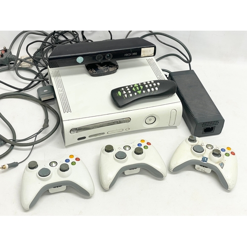 209 - An XBOX 360 console with 3 controllers, a Kinect, an XBOX remote and leads.