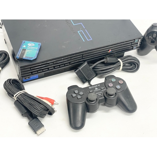 210 - A PlayStation 2 (PS2) with 2 controllers, memory card and leads.