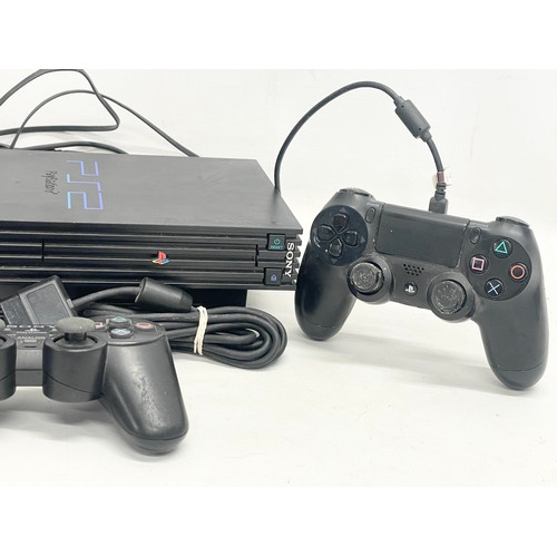 210 - A PlayStation 2 (PS2) with 2 controllers, memory card and leads.