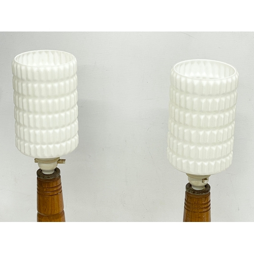 154 - A pair of tall 1950’s oak table lamps with glass shades. 21x56cm