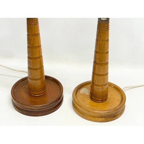 154 - A pair of tall 1950’s oak table lamps with glass shades. 21x56cm