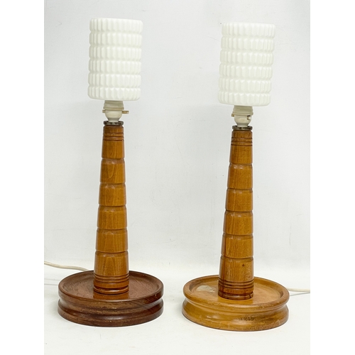 154 - A pair of tall 1950’s oak table lamps with glass shades. 21x56cm