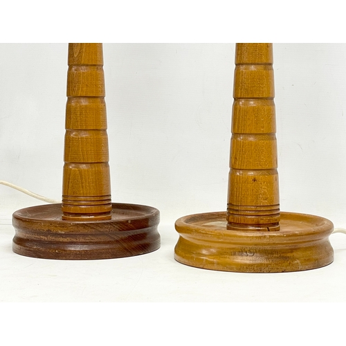 154 - A pair of tall 1950’s oak table lamps with glass shades. 21x56cm