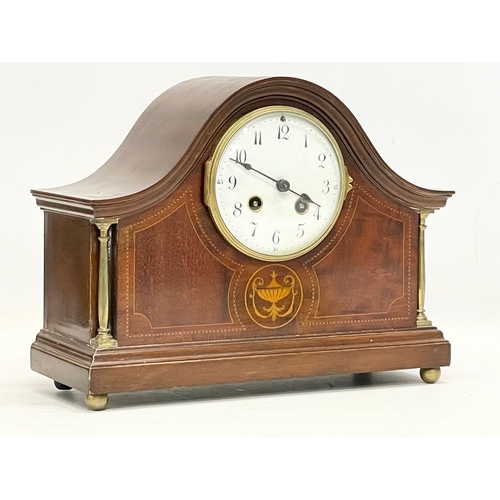 329 - An Edwardian inlaid mahogany mantle clock. With key and pendulum. 30x12x23cm