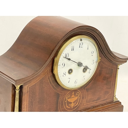 329 - An Edwardian inlaid mahogany mantle clock. With key and pendulum. 30x12x23cm