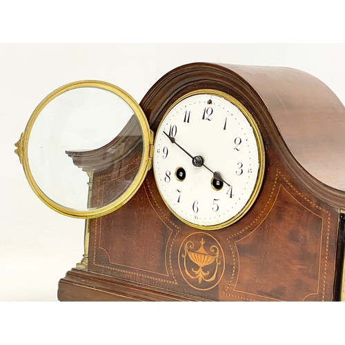 329 - An Edwardian inlaid mahogany mantle clock. With key and pendulum. 30x12x23cm