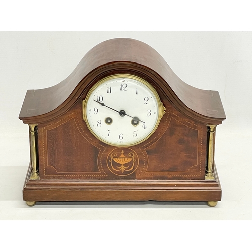 329 - An Edwardian inlaid mahogany mantle clock. With key and pendulum. 30x12x23cm