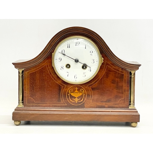 329 - An Edwardian inlaid mahogany mantle clock. With key and pendulum. 30x12x23cm