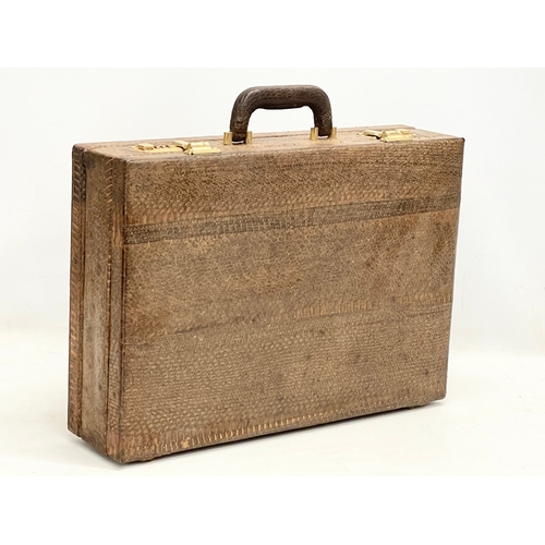 403 - A vintage snake skin briefcase. With a large snake skin. Briefcase measures 44x31x11cm.