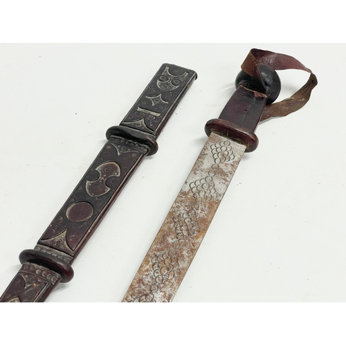 331 - A West African leather bound tribal sword. 66cm