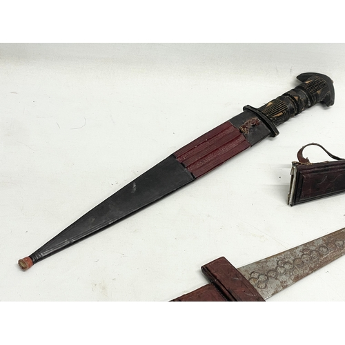 332 - 2 West African leather bound tribal knives. 41cm