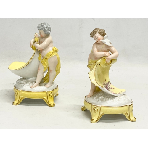 97 - A pair of late 19th/early 20th century German porcelain cherub stands. 13x16.5cm