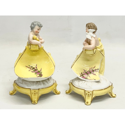 97 - A pair of late 19th/early 20th century German porcelain cherub stands. 13x16.5cm