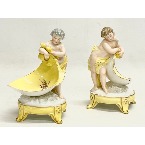 97 - A pair of late 19th/early 20th century German porcelain cherub stands. 13x16.5cm