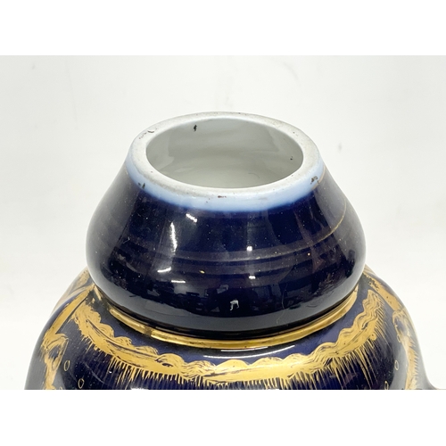 157 - An early 20th century German gilt colt blue porcelain urn. Converted from a lamp. 18x26cm.